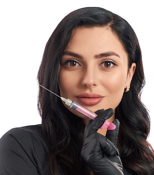 Beauty professional holding syringe for dermal filler injection treatment to enhance facial features