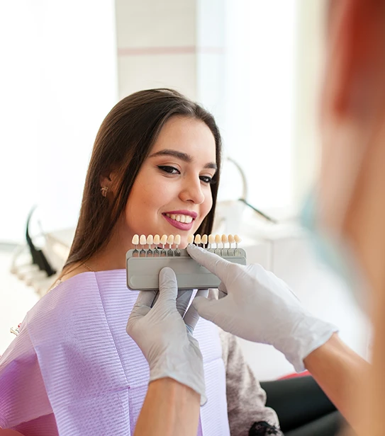 A patient smiling after composite bonding treatment at a dental clinic