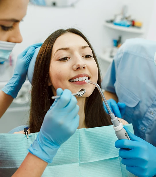 dentist performing professional teeth cleaning on patient