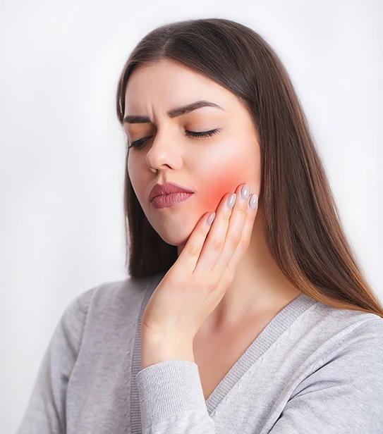 Woman experiencing sharp tooth pain and dental emergency symptoms requiring urgent care.